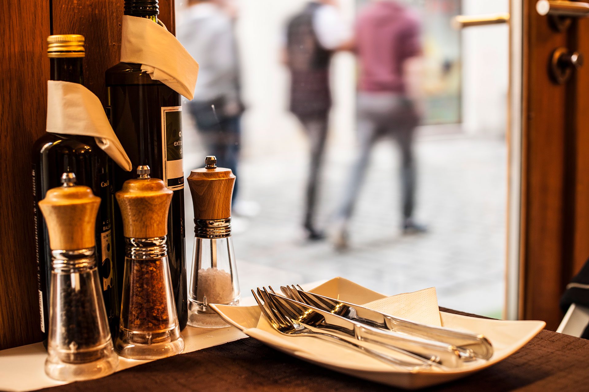 restaurant table with salt shakers and cutlery