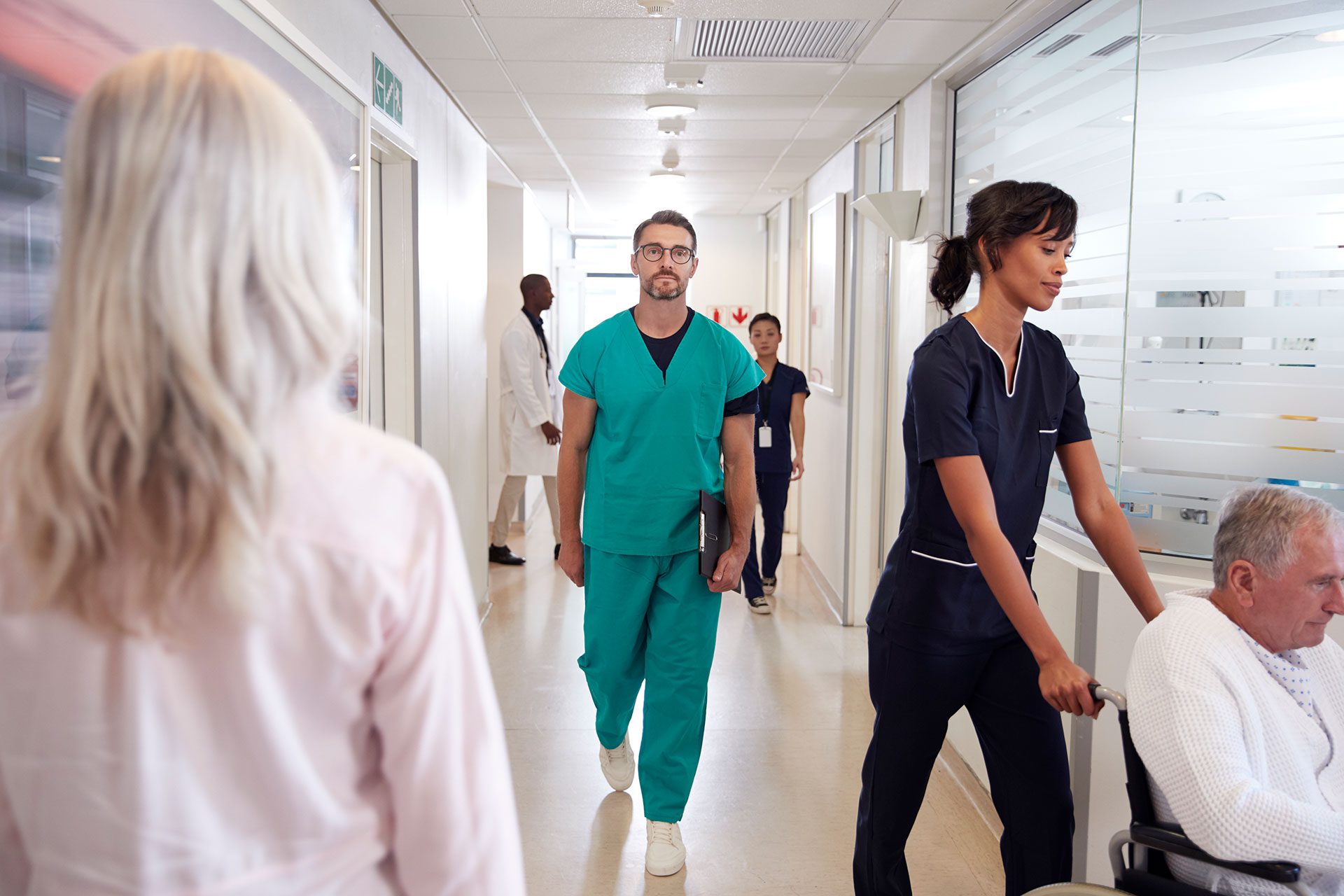 busy hospital corridor with medical staff and patients