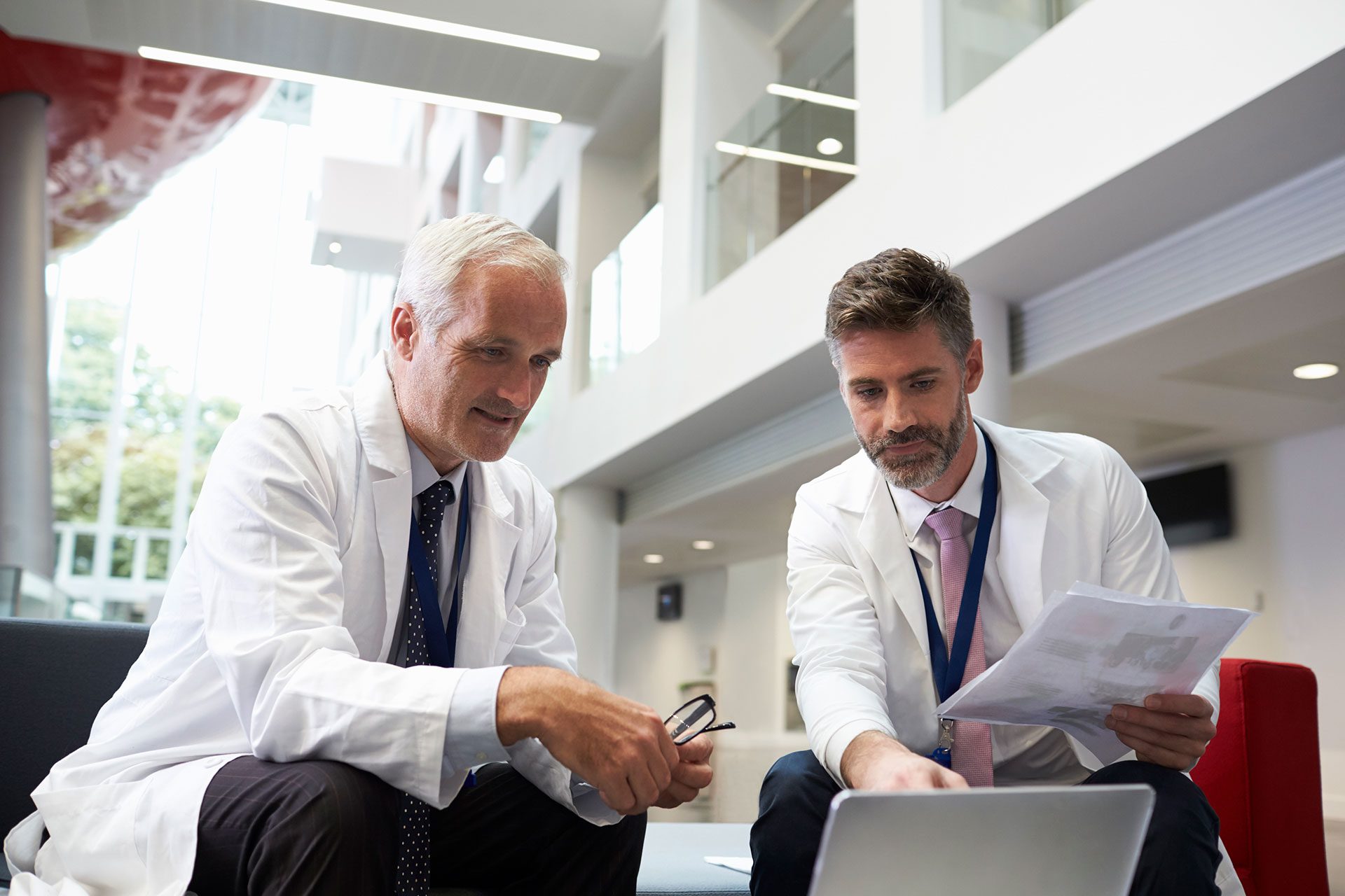 Professionals discussing about the medical real estate in a hospital room